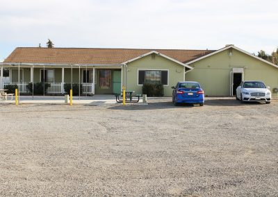 A centered view from the parking lot, looking towards the service entrance door, High Desert Hall, Hesperia, CA.